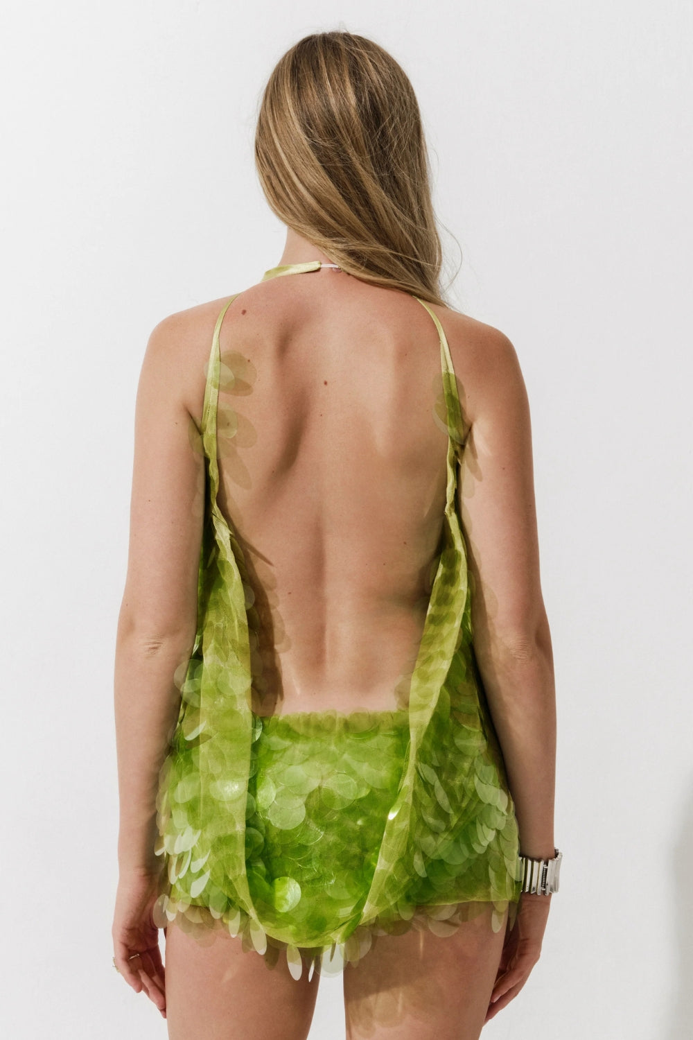 Cultnaked Matcha Jumpsuit in green recycled polyester. Back view of open-back halter jumpsuit. Made in Ukraine, at MIXMVSE London.