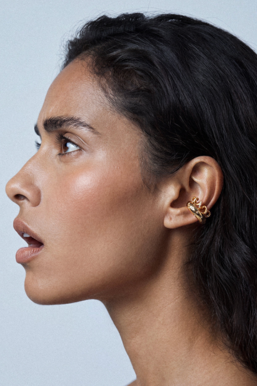 Chuk gold Spiral ear cuff worn on the ear. Ukrainian designer jewellery at MIXMVSE London.