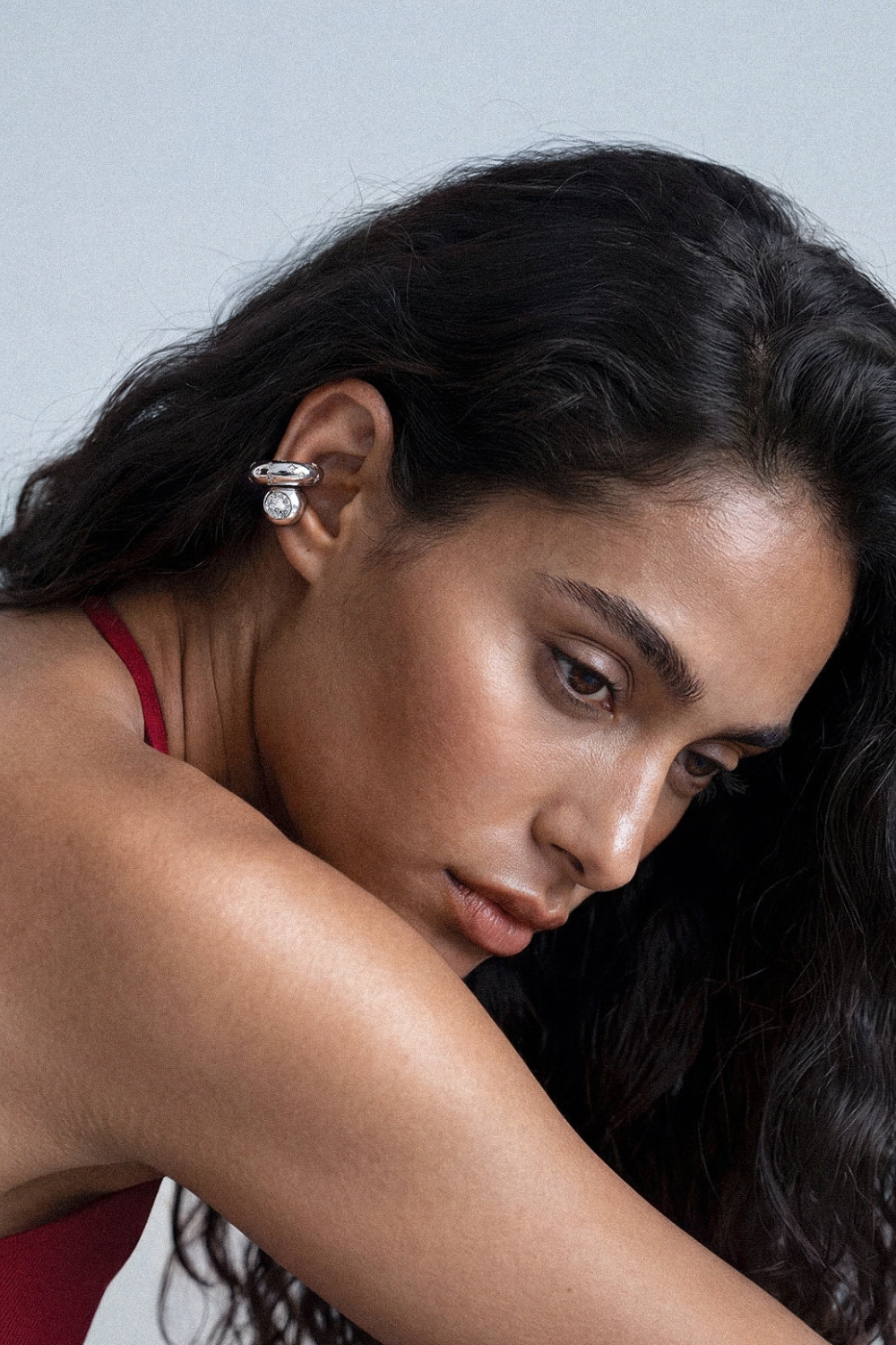 Chuk silver Bold Drop ear cuff worn on the ear. Ukrainian designer jewellery at MIXMVSE London.