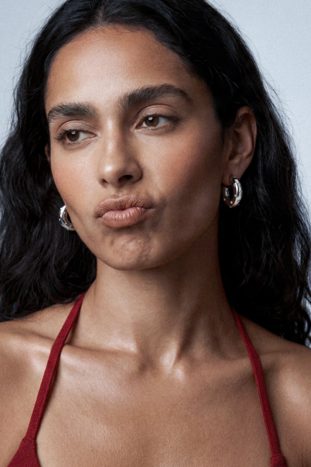 Chuk silver Raw Desire earrings worn on the ear. Ukrainian designer jewellery at MIXMVSE London.