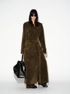 LAFORMELA Vintage Effect long olive velvet trench coat styled with oversized black luxury handbag MIXMVSE London