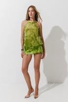 Cultnaked Matcha Jumpsuit in matcha green. Front view of halter-neck jumpsuit in recycled polyester. Independent Ukrainian designer at MIXMVSE London.