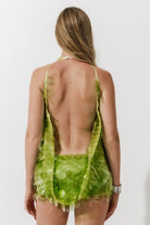 Cultnaked Matcha Jumpsuit in green recycled polyester. Back view of open-back halter jumpsuit. Made in Ukraine, at MIXMVSE London.
