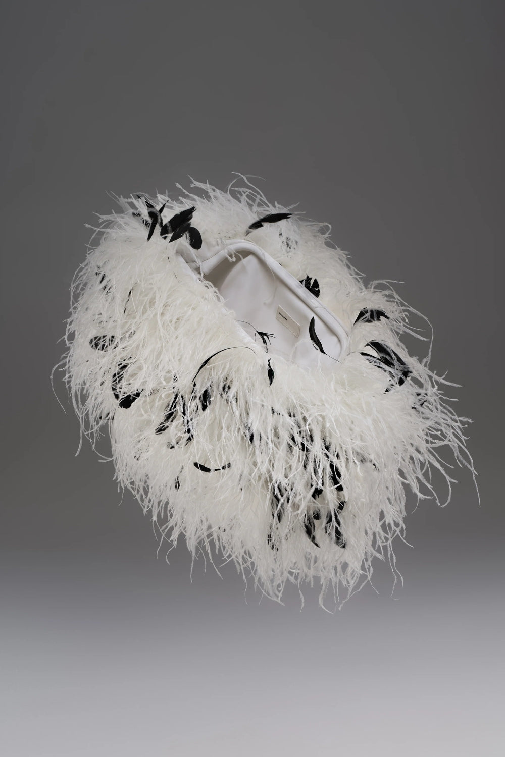 Cultnaked Snap Clutch in Dalmatian ostrich feather. Front view of evening clutch with clasp closure. Independent Ukrainian designer at MIXMVSE London.