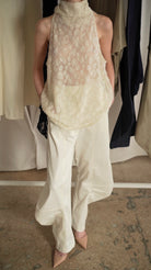 KARPOVA Semi-Sheer Turtleneck Top in white. Back view showing button fastening detail. Available at MIXMVSE London concept store.