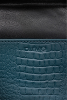 Du'Mo Poise Small Bag detail of the debossed Du'Mo logo on sea wave crocodile-embossed leather. Independent Ukrainian designer at MIXMVSE London.