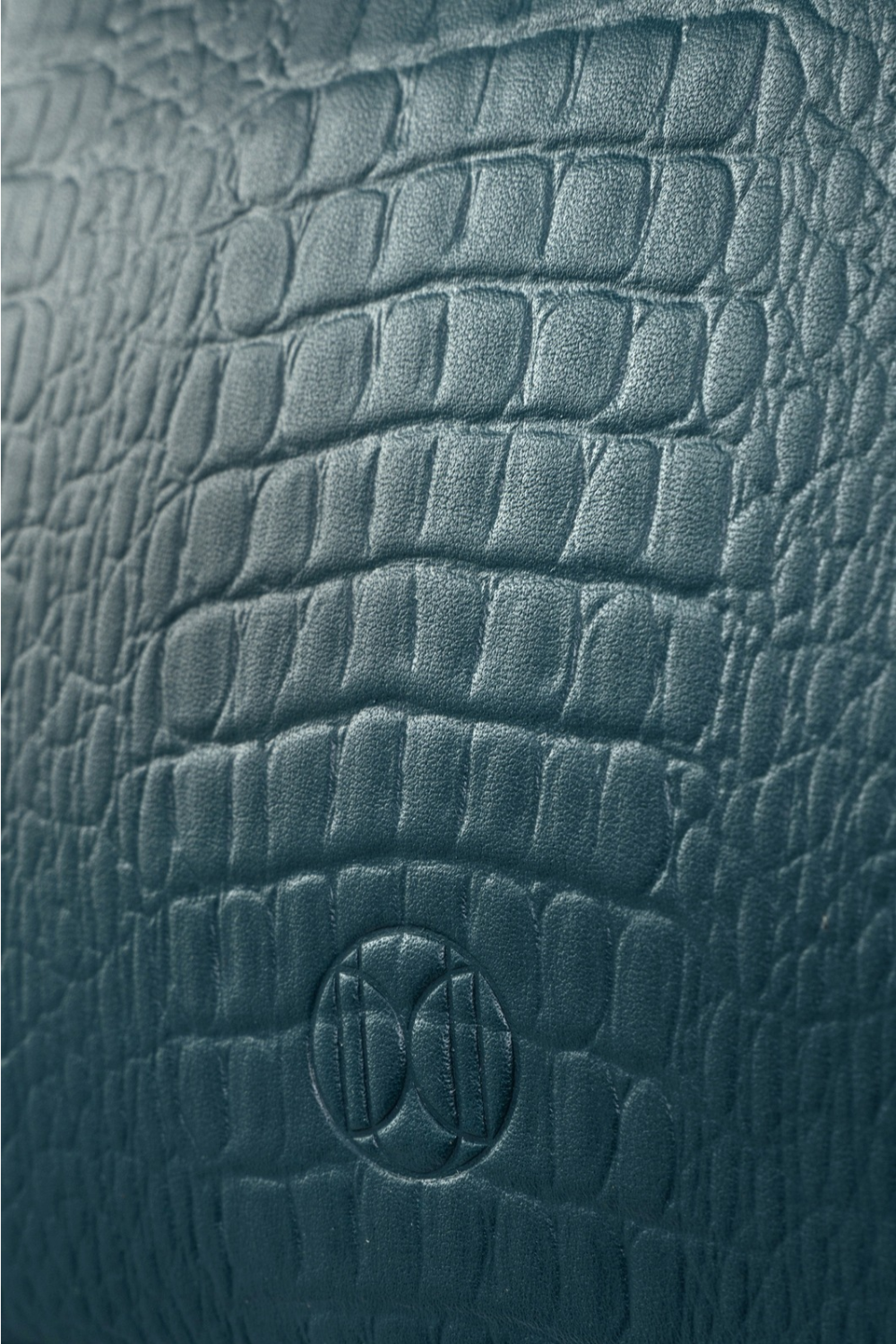 Du'Mo Poise Small Bag close-up of sea wave crocodile-embossed leather with debossed monogram. Independent Ukrainian designer at MIXMVSE London.