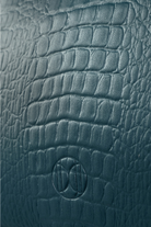 Du'Mo Poise Small Bag close-up of sea wave crocodile-embossed leather with debossed monogram. Independent Ukrainian designer at MIXMVSE London.