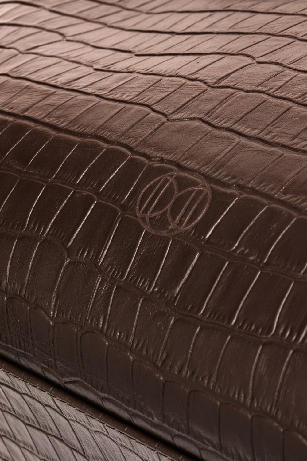 Du'Mo Portfolio Bag close-up of brown crocodile-embossed leather with debossed Du'Mo monogram. Independent Ukrainian designer at MIXMVSE London.