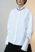 Ambitna classic white shirt with buttoned cuffs worn on model. Independent Ukrainian designer at MIXMVSE London.