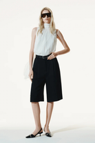 Ambitna tailored Bermuda shorts in black viscose and linen with wide legs. Independent Ukrainian designer at MIXMVSE London.