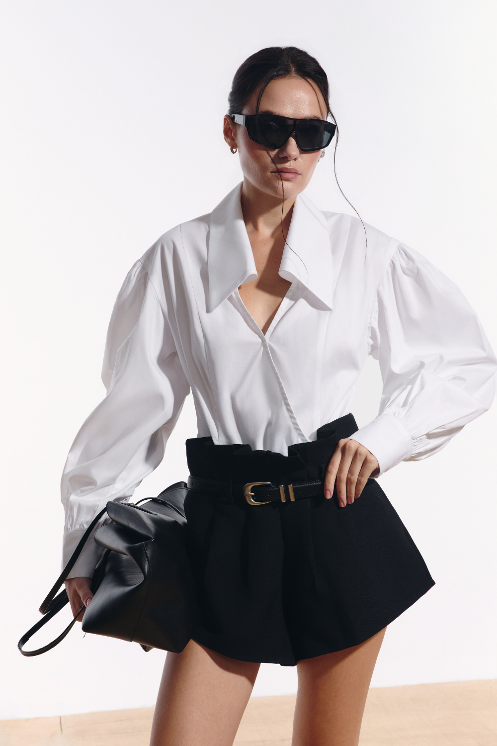Ambitna white cotton shirt with wide sleeves styled with black wool mini shorts. Independent Ukrainian designer at MIXMVSE London.