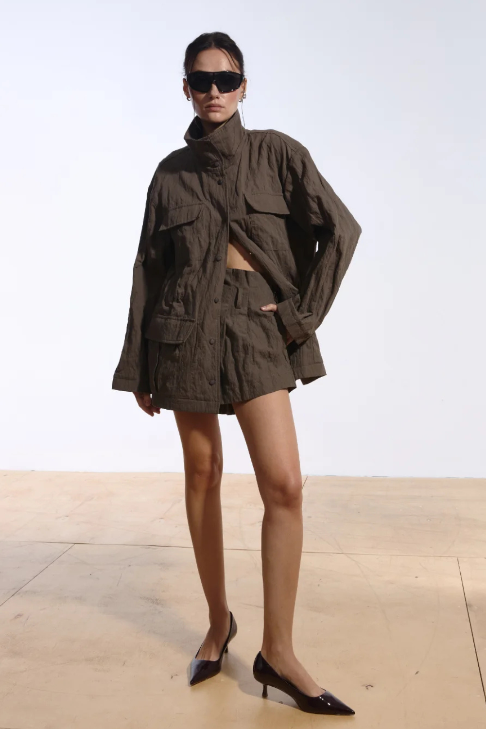 Ambitna crinkled jacket in khaki cotton, front view of the relaxed military-inspired silhouette. Independent Ukrainian designer at MIXMVSE London.