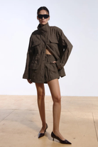 Ambitna crinkled jacket in khaki cotton, front view of the relaxed military-inspired silhouette. Independent Ukrainian designer at MIXMVSE London.