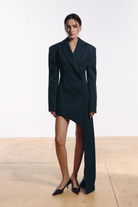 Ambitna asymmetric jacket in emerald wool, front view with padded shoulders. Independent Ukrainian designer at MIXMVSE London.