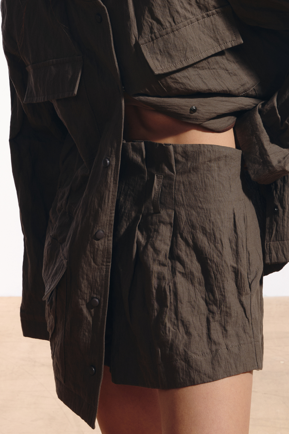 Ambitna crinkled mini shorts in khaki cotton, styled full look. Independent Ukrainian designer at MIXMVSE London.