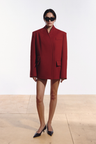 Ambitna red coat in wool and cashmere, front view of the longline silhouette with V-line neckline. Independent Ukrainian designer at MIXMVSE London.