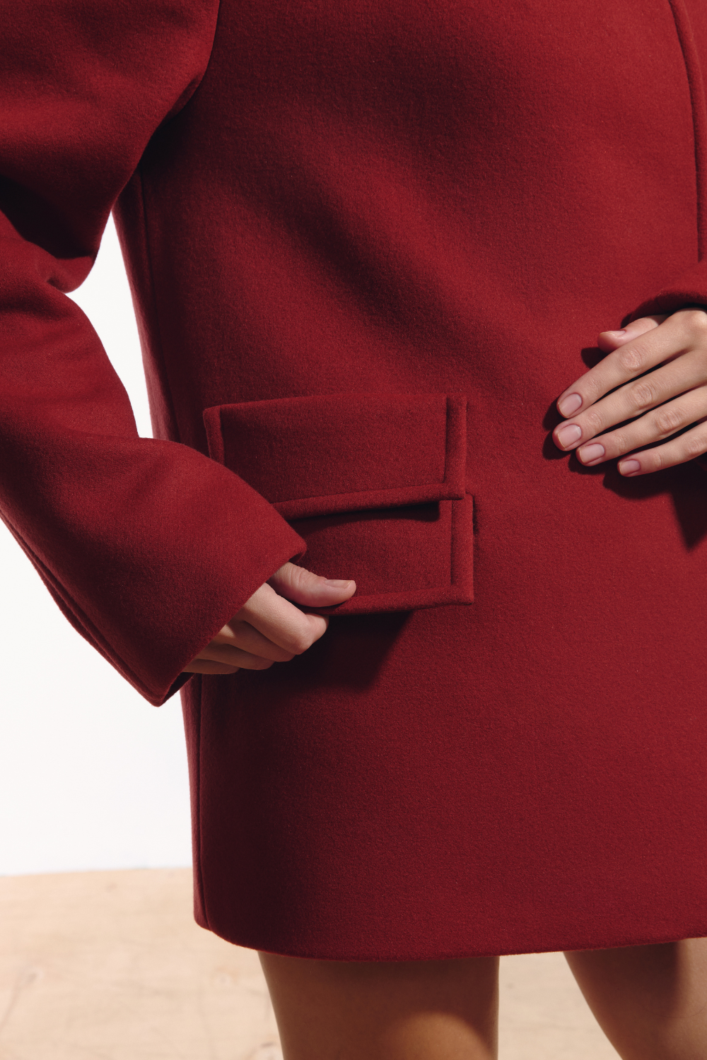Ambitna red wool and cashmere coat, side view showing the full length. Independent Ukrainian designer at MIXMVSE London.