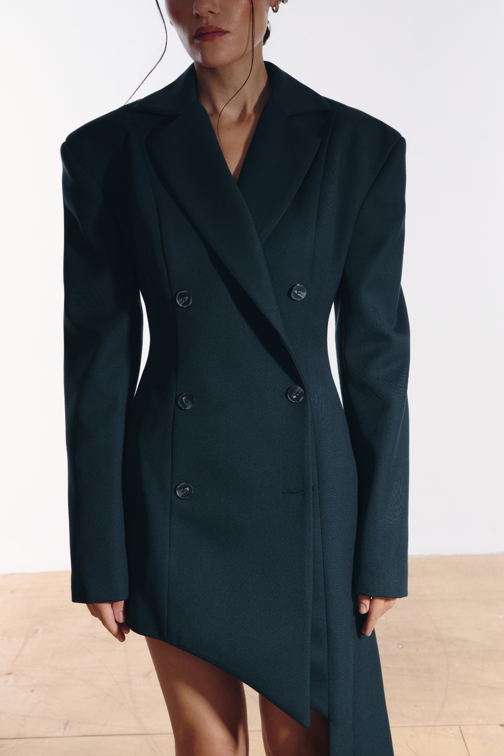 Ambitna emerald wool asymmetric jacket, side view showing the structured silhouette. Independent Ukrainian designer at MIXMVSE London.