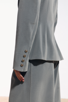 Ambitna velvet blazer in grey wool, side view showing the structured shoulder line. Independent Ukrainian designer at MIXMVSE London.