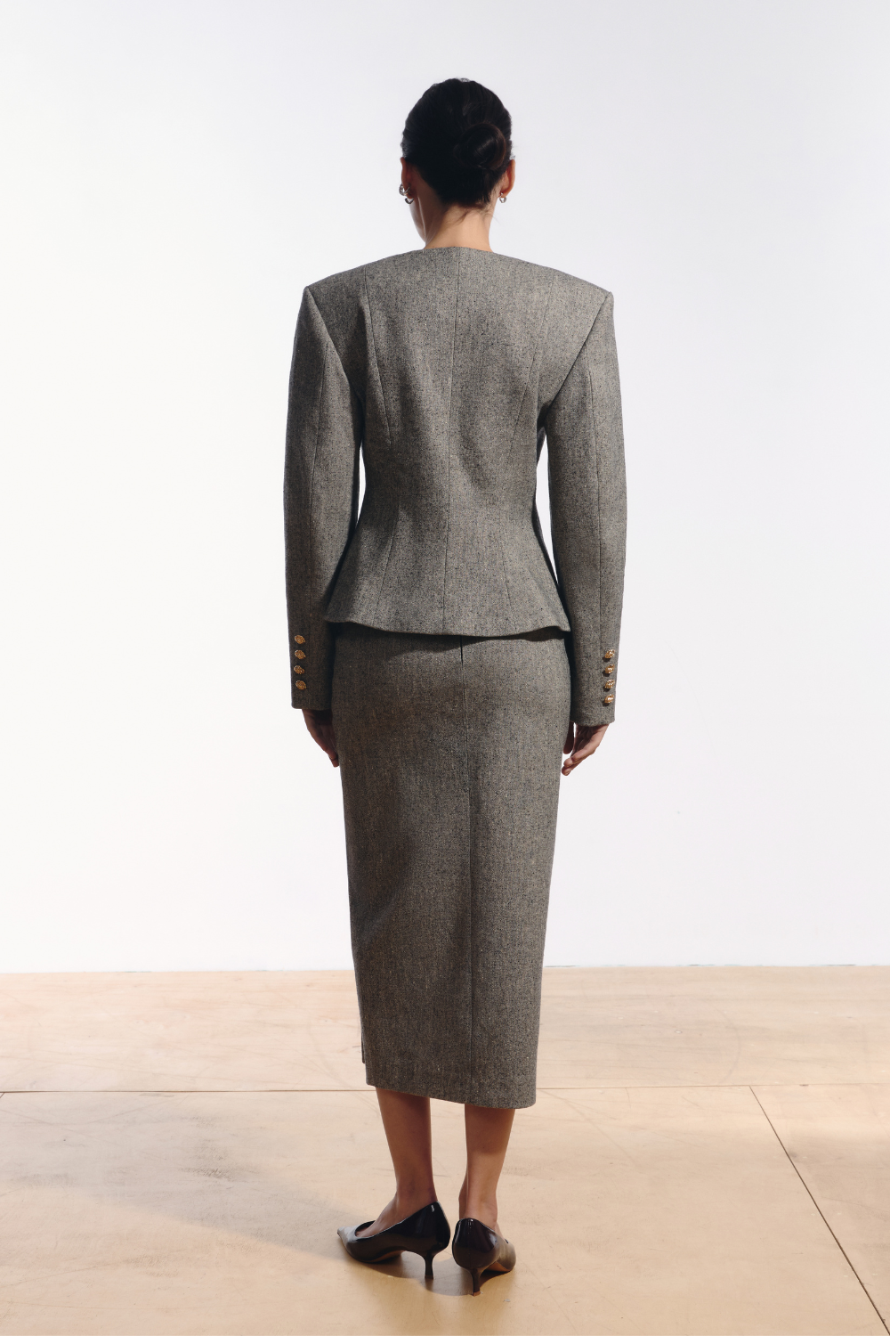 Ambitna grey tweed jacket, detail of the gold buttons on the front closure. Independent Ukrainian designer at MIXMVSE London.