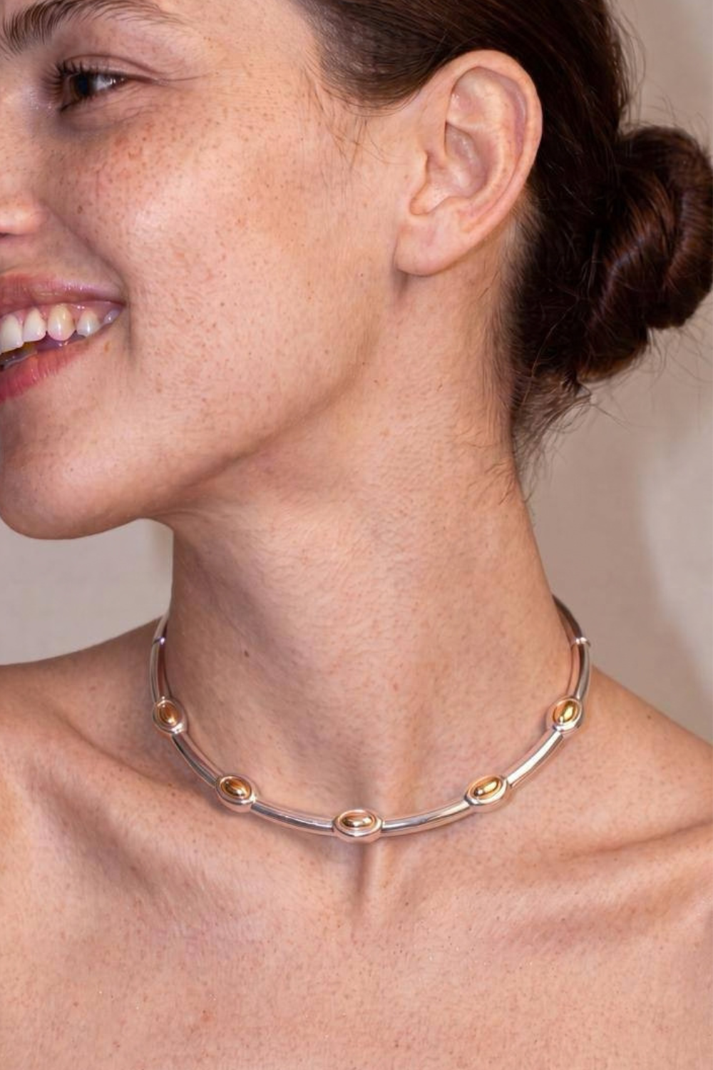 Chuk Form silver necklace worn on the neck. Ukrainian designer jewellery at MIXMVSE London.