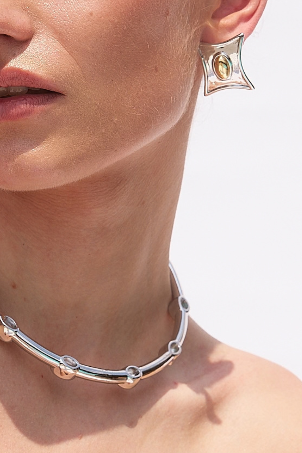 Chuk Form silver earrings worn on the ear. Ukrainian designer jewellery at MIXMVSE London.