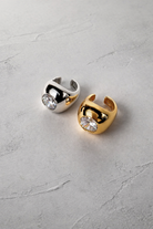 Chuk Bold Drop ear cuffs in silver and gold, styled together. Ukrainian designer jewellery at MIXMVSE London.